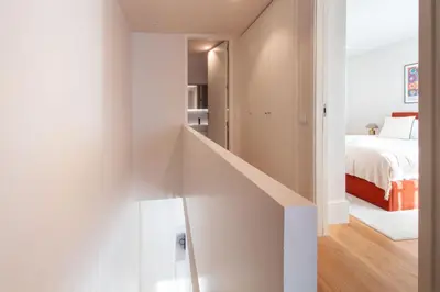 a staircase leading to a bedroom with a bed at Miguel Bombarda House in Porto
