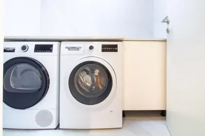 a washing machine and a dryer in a laundry room at Miguel Bombarda House in Porto