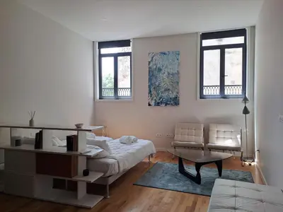 a living room with a bed and a couch at H2OPorto Miragaia - Riverfront apartments in Porto historic district in Porto