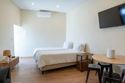 a bedroom with a bed and a table and a tv at Studio at Campanha Station in Porto