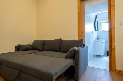 a living room with a couch and a table at Studio at Campanha Station in Porto