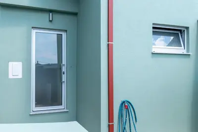 a green building with a door and a window at Studio at Campanha Station in Porto