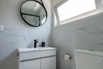 a bathroom with a mirror and a sink at Studio at Campanha Station in Porto