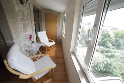 a room with two chairs and a window at Cedofeita Back Garden in Porto