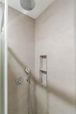 a shower with a shower head in a bathroom at HostWise - Premium & Modern Building in Porto