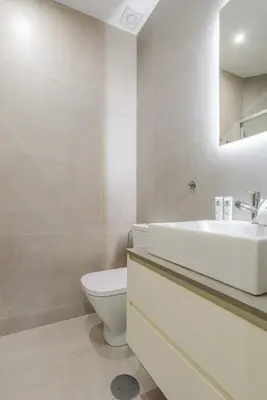 a white bathroom with a sink and a toilet at HostWise - Premium & Modern Building in Porto