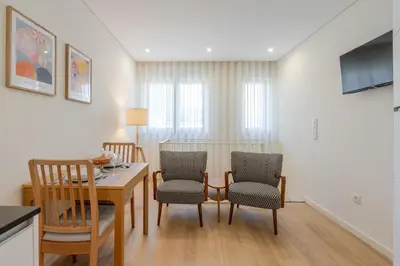 a kitchen and dining room with a table and chairs at HostWise - Premium & Modern Building in Porto