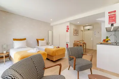 a hotel room with a bed and a kitchen at HostWise - Premium & Modern Building in Porto