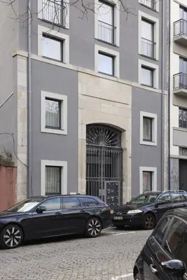 two cars parked in front of a building at FLH Porto Central Apartments in Porto