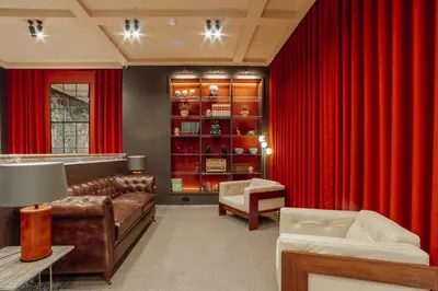 a room with a red curtain and a bar at ABC Hotel Porto - Campanhã in Porto