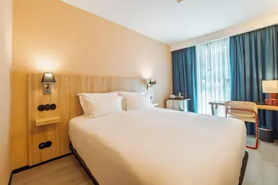 a large white bed in a hotel room at ABC Hotel Porto - Campanhã in Porto