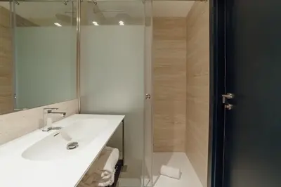 a bathroom with a sink and a shower at ABC Hotel Porto - Campanhã in Porto