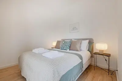 a living room with a couch and a television at The Bright Life @ BoaVista Flats in Porto