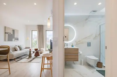 a living room with a couch and a table at The Bright Life @ BoaVista Flats in Porto