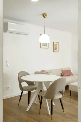 a dining room with a white table and chairs at VIVA River Apartment Gaia in Vila Nova de Gaia