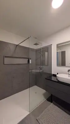 a bathroom with a glass shower and a sink at Castelo River View - NEW in Vila Nova de Gaia