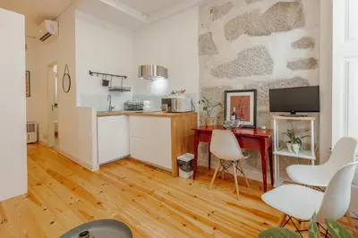 a kitchen and living room with a table and chairs at Marques 1243 by Vacationy in Porto