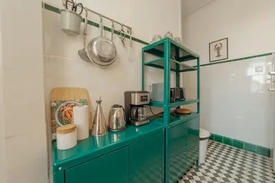 a green cabinet in a kitchen with a counter top at Downtown Retro Bolhao by Vacationy in Porto