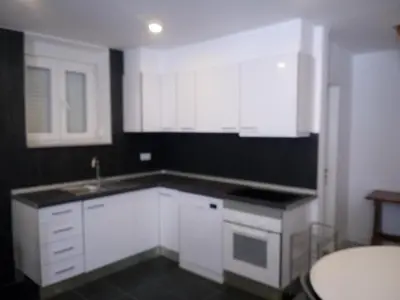 an empty kitchen with white cabinets and a sink at Casa Pedro Hispano 3B in Porto