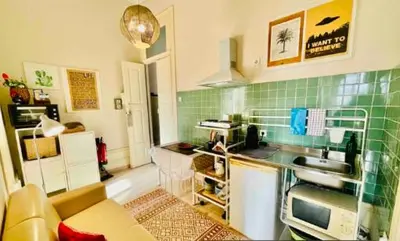 a kitchen with green tiled walls and a sink at aiPorto downtown, family&friends 2! in Porto