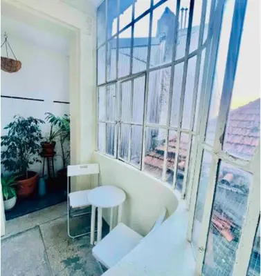 a room with a table and a stool in front of a window at aiPorto downtown, family&friends 2! in Porto
