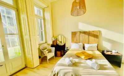 a bedroom with a bed and a room with a window at aiPorto downtown, family&friends 2! in Porto