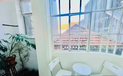 a living room with a window and a white couch at aiPorto downtown, family&friends 2! in Porto