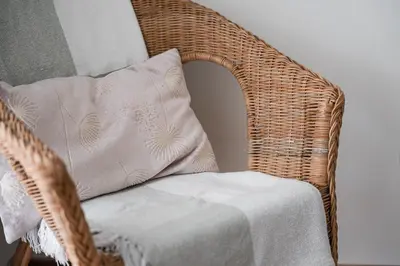 a wicker chair with a pillow on top of it at GuestReady - Cityscape residence with balcony in Porto