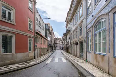 an empty street in an alley with buildings at Art Deco 31 Luxury 2BR Apartment Downtown Metro AC in Porto