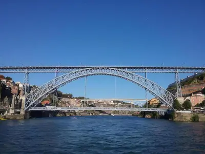 a white bridge over a river with a river at Feel Porto Bacchus Townhouse in Porto