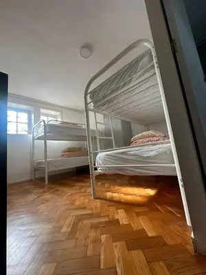 two bunk beds in a room with a wooden floor at O2 Hostel in Porto