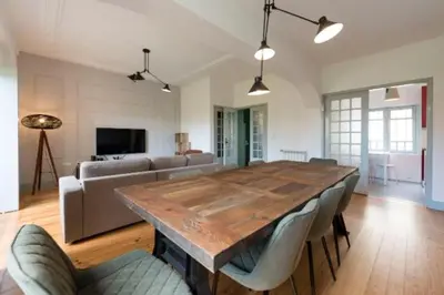 a living room with a wooden table and a couch at Douro Central in Porto
