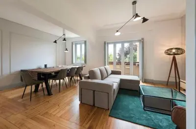 a living room with a couch and a dining room table at Douro Central in Porto