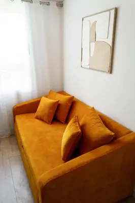 a large brown couch sitting in a room at Green Universe Porto by MyMoradia in Porto
