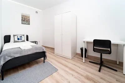 a bedroom with a bed and a desk and a chair at Gaia Family Nest in Vila Nova de Gaia