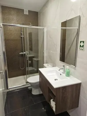 a bathroom with a sink and a shower and a toilet at Campanhã Clock House with terrace in Porto