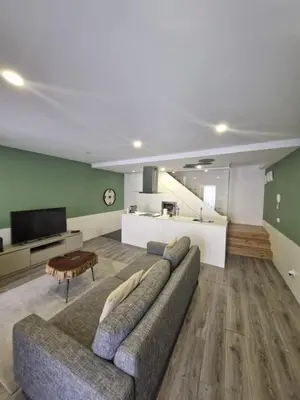 a living room with a couch and a tv at Campanhã Clock House with terrace in Porto