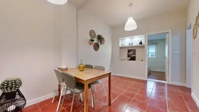 a dining room with a wooden table and chairs at Porto Sweet Home in Porto