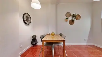 a dining room with a wooden table and chairs at Porto Sweet Home in Porto