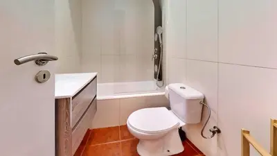 a bathroom with a toilet and a sink and a tub at Porto Sweet Home in Porto