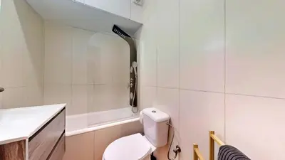 a white bathroom with a toilet and a sink at Porto Sweet Home in Porto