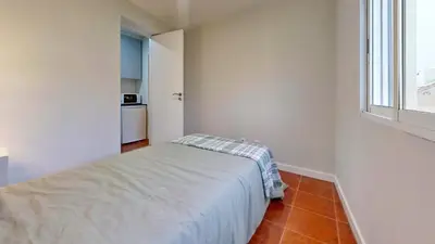 a small bedroom with a bed and a window at Porto Sweet Home in Porto