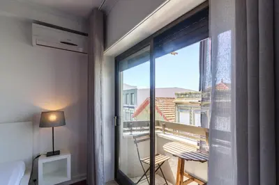 a room with a window with a view of a balcony at Lindo Vale Guest House in Porto