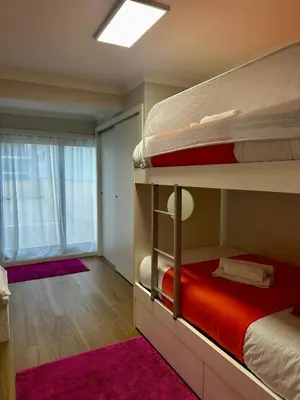 a bedroom with two bunk beds and a window at Douro Sunset Terrace in Vila Nova de Gaia