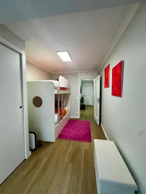 an empty room with a bed and a pink rug at Douro Sunset Terrace in Vila Nova de Gaia