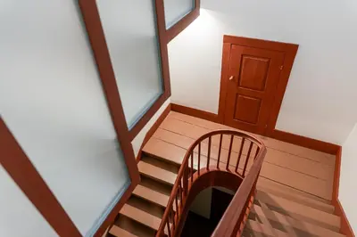 a wooden staircase in a room with two windows at GuestReady - Joy Apartments in Porto