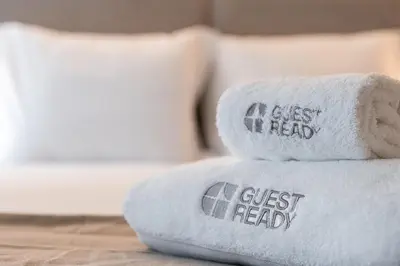 a stack of folded towels with writing on them at GuestReady - Joy Apartments in Porto