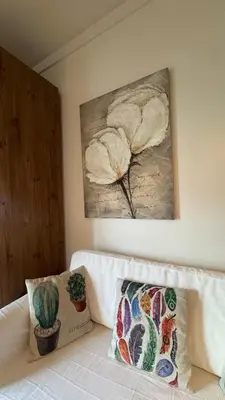 a painting on the wall above a couch in a room at Covelo in Porto