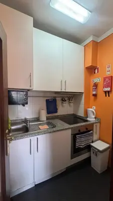 a kitchen with white cabinets and a sink at Covelo in Porto
