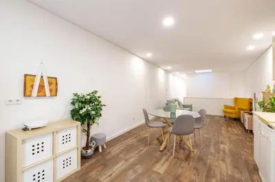 a kitchen and dining room with a table and chairs at VIVA Spacious Apartment Campanhã in Porto